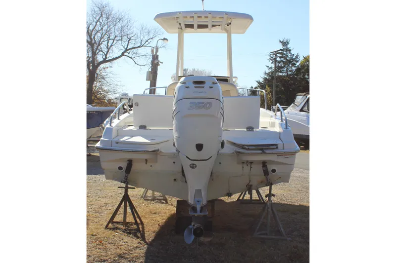 Slide: The Image of 2020 Boston Whaler 240 Dauntless boat with powerful outboard motor, displayed on stands. - 5