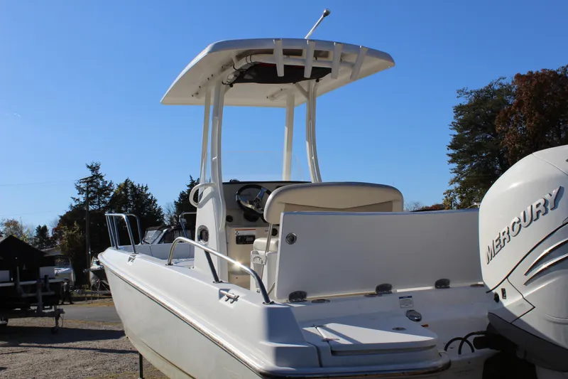 Slide: The Image of 2020 Boston Whaler 240 Dauntless boat with Mercury engine, docked outdoors. - 6