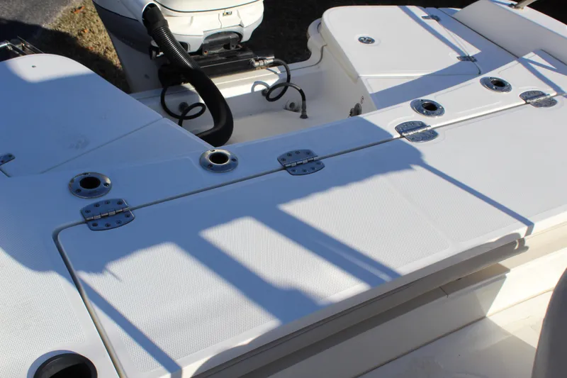 Slide: The Image of 2020 Boston Whaler 240 Dauntless boat deck with storage compartments and rod holders. - 7