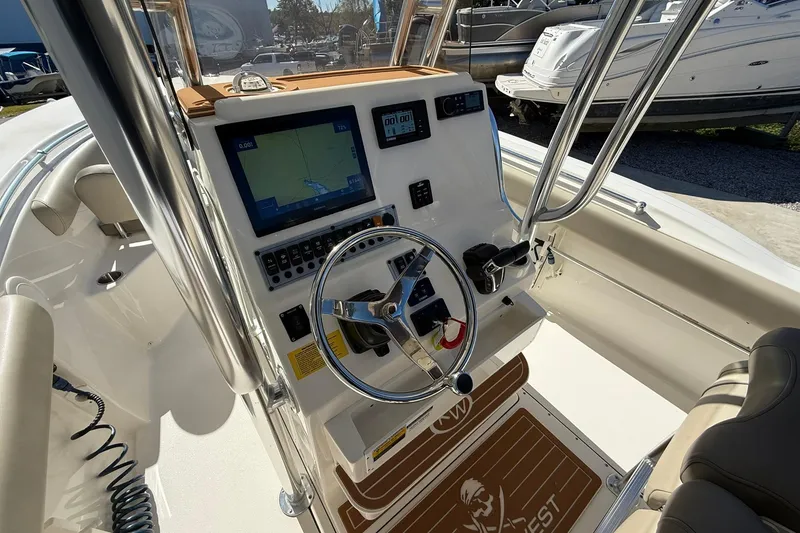 Slide: The Image of 2026 Key West 244 Center Console boat dashboard with navigation system and steering wheel. - 12