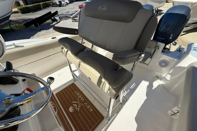 Slide: The Image of 2026 Key West 244 Center Console boat interior with seating and steering wheel. - 17