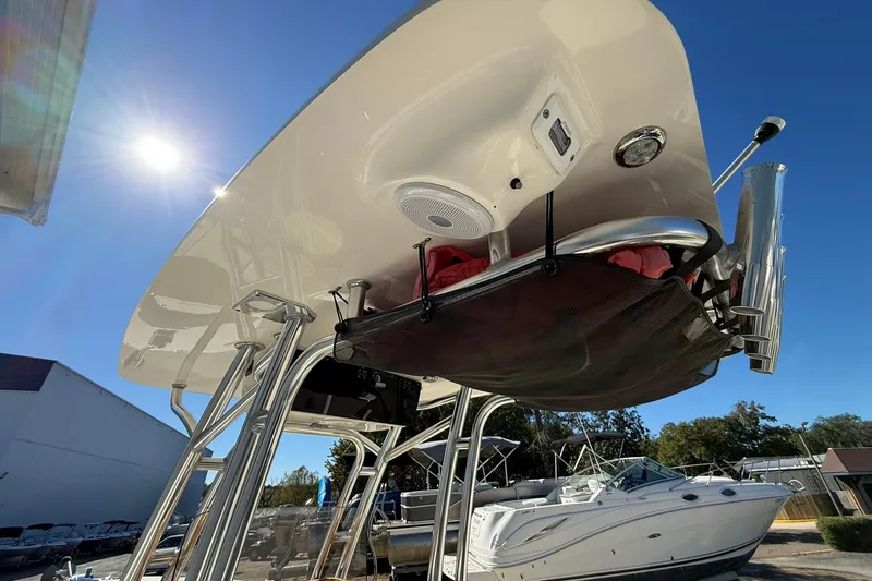 Slide: The Image of 2026 Key West 244 Center Console boat under sunny sky, showcasing T-top and storage. - 18