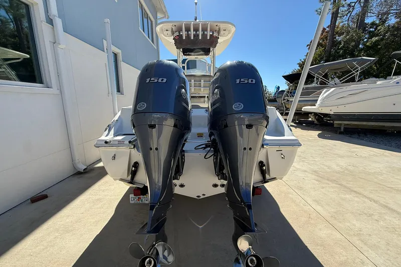 Slide: The Image of 2026 Key West 244 Center Console boat with dual Yamaha 150 engines, docked outdoors. - 3