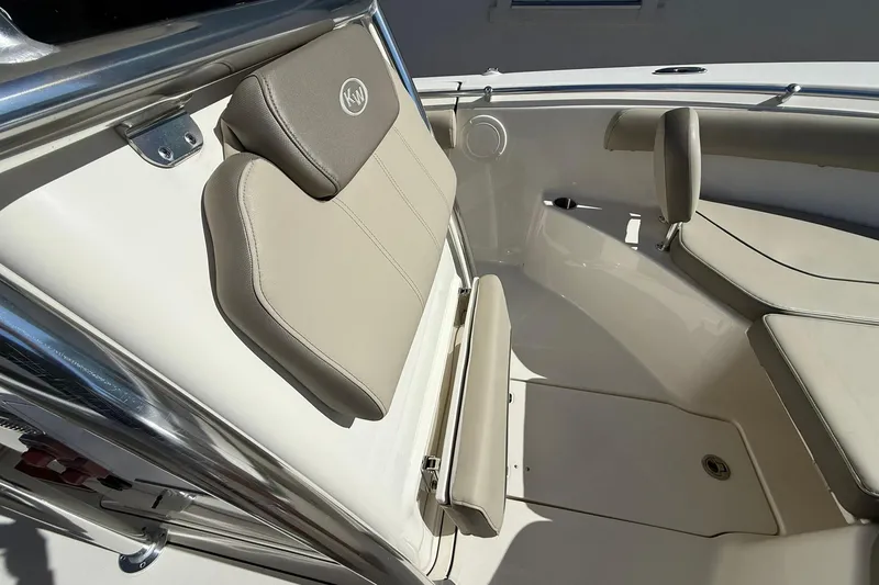 Slide: The Image of 2026 Key West 244 Center Console boat interior with beige seating and stainless steel accents. - 7