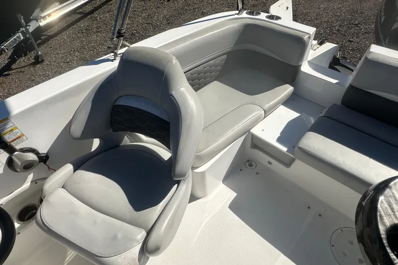 Slide: The Image of 2020 Hurricane SunDeck Sport 192 RL OB boat interior with gray seating and steering wheel. - 17