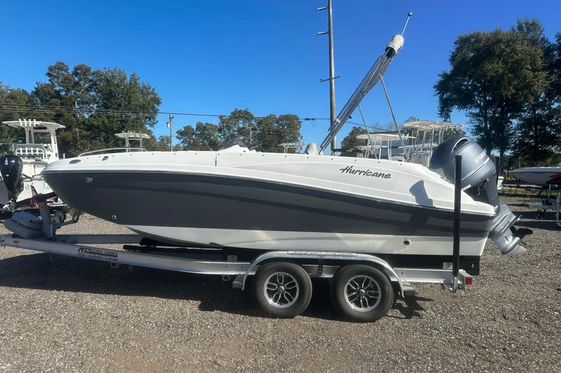 Slide: The Image of 2020 Hurricane SunDeck Sport 192 RL OB boat on trailer, parked outdoors. - 2