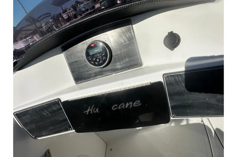 Slide: The Image of 2020 Hurricane SunDeck Sport 192 RL OB dashboard with control panel and logo. - 24