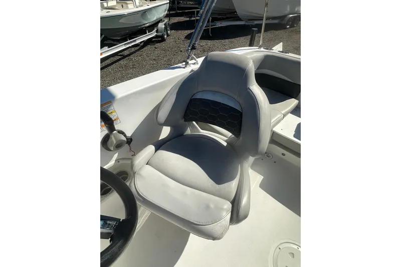 Slide: The Image of 2020 Hurricane SunDeck Sport 192 RL OB boat seat, gray upholstery, steering wheel visible. - 29