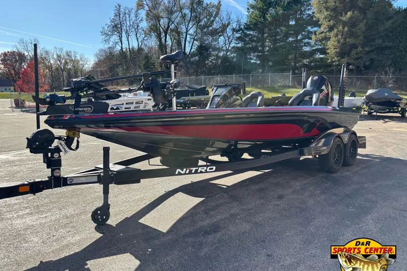 Slide: The Image of 2024 Nitro Z21 XL boat on trailer, parked outdoors, with trees in the background. - 3
