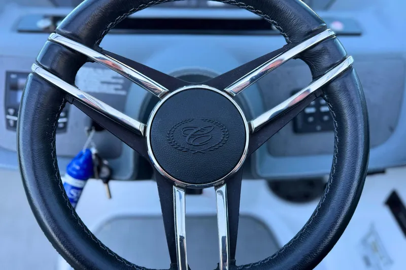 Slide: The Image of Steering wheel of a 2019 Cobalt 25SC boat, featuring sleek chrome accents. - 22