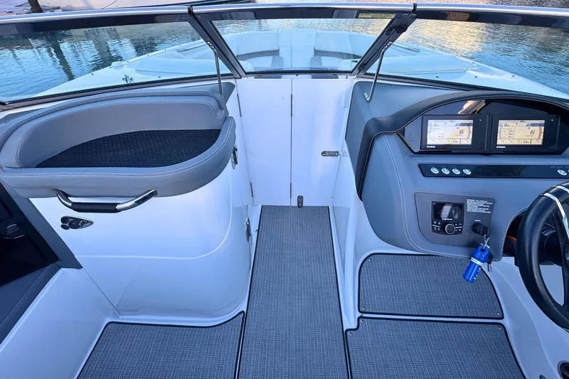 Slide: The Image of 2019 Cobalt 25SC boat interior with modern dashboard and seating. - 26