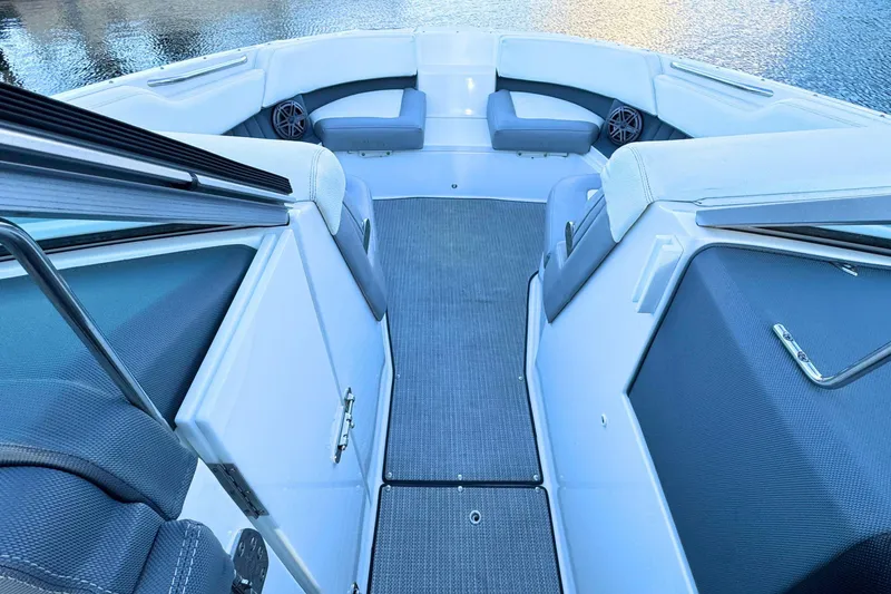 Slide: The Image of 2019 Cobalt 25SC boat interior with cushioned seating and water view. - 28