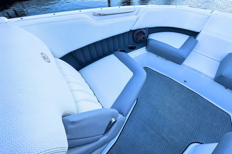 Slide: The Image of 2019 Cobalt 25SC boat interior with cushioned seating and speaker. - 30