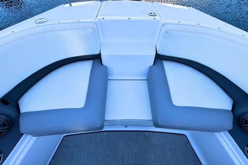 Slide: The Image of 2019 Cobalt 25SC boat interior with cushioned seating and water view. - 31