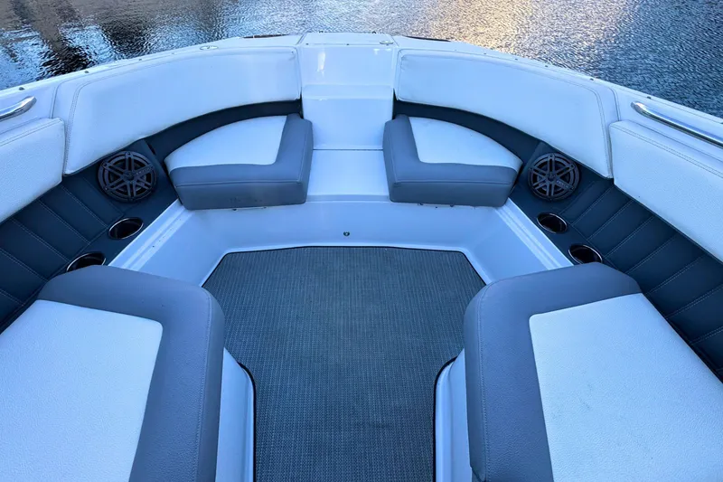 Slide: The Image of 2019 Cobalt 25SC boat interior with cushioned seating and cup holders. - 32