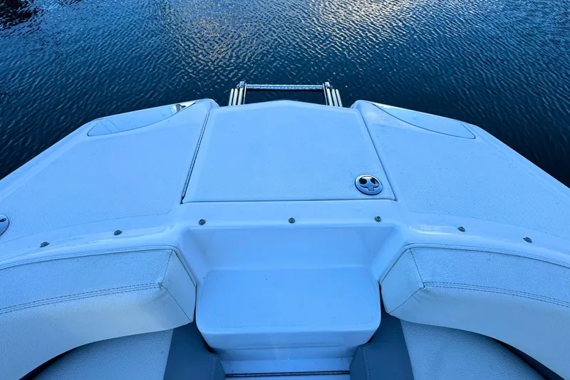 Slide: The Image of 2019 Cobalt 25SC boat stern view with swim platform on calm water. - 33