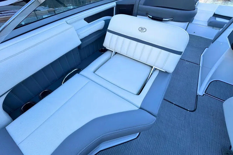 Slide: The Image of 2019 Cobalt 25SC boat interior with white and gray seating, cup holders visible. - 36