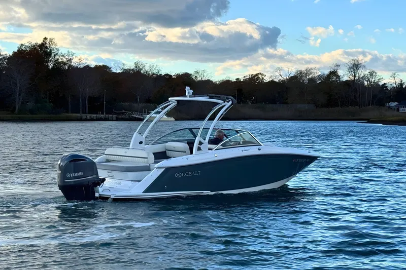 Slide: The Image of 2019 Cobalt 25SC boat cruising on a scenic lake with Yamaha outboard motor. - 7