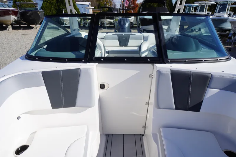 Slide: The Image of 2026 Chaparral 23 SSi OB boat interior with sleek seating and windshield design. - 17