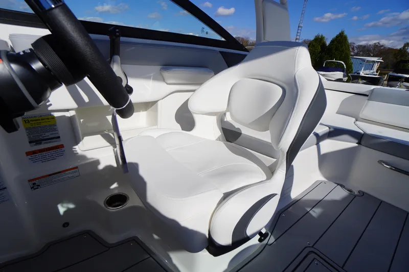 Slide: The Image of 2026 Chaparral 23 SSi OB boat interior with white captain's seat and steering wheel. - 25