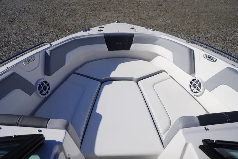 Slide: The Image of 2026 Chaparral 23 SSi OB boat interior with white cushioned seating and speakers. - 4