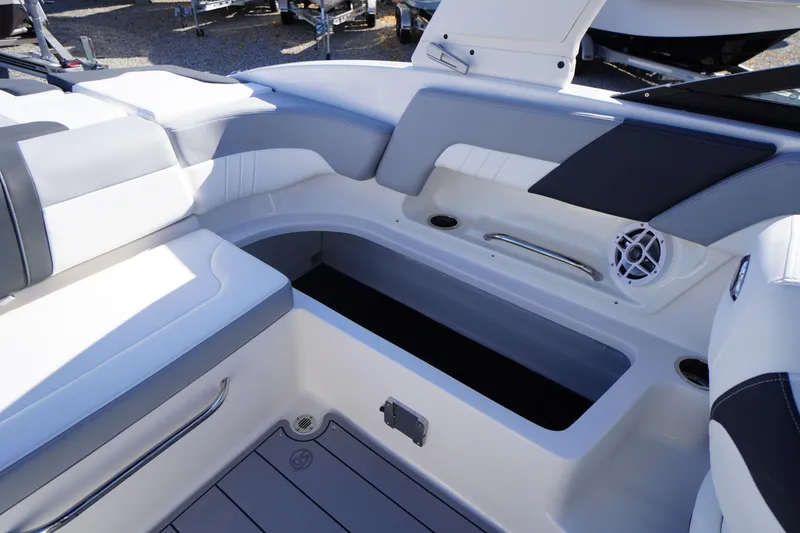Slide: The Image of 2026 Chaparral 23 SSi OB boat interior with white seating and storage compartment. - 50