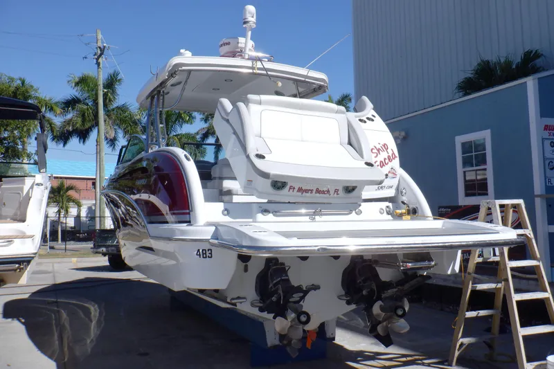 Slide: The Image of 2015 Formula 350 Crossover Bowrider boat docked, rear view, sunny day, palm trees. - 54
