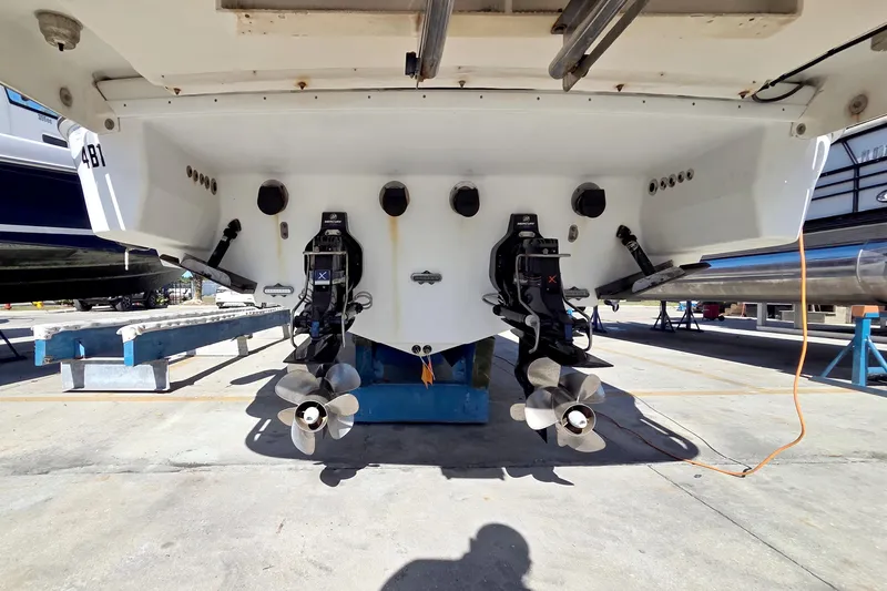 Slide: The Image of 2015 Formula 350 Crossover Bowrider boat with dual propellers in dry dock. - 55