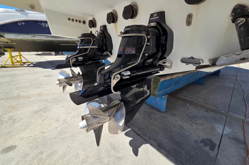 Slide: The Image of 2015 Formula 350 Crossover Bowrider with dual Mercury outdrives in a boatyard setting. - 56
