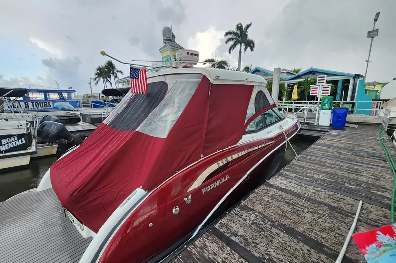 Slide: The Image of 2015 Formula 350 Crossover Bowrider docked with red cover and American flag. - 64