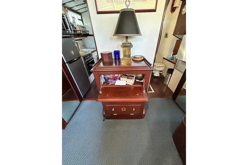 Slide: The Image of Interior of a 1930 Classic 47' ACF boat with wooden furniture and lamp. - 12