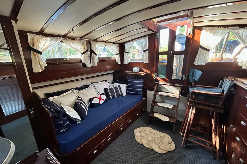 Slide: The Image of Interior of a 1930 Classic 47' ACF boat with cozy seating and nautical decor. - 14