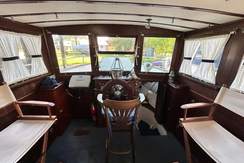 Slide: The Image of Interior of a 1930 Classic 47' ACF boat with wooden helm and vintage decor. - 15