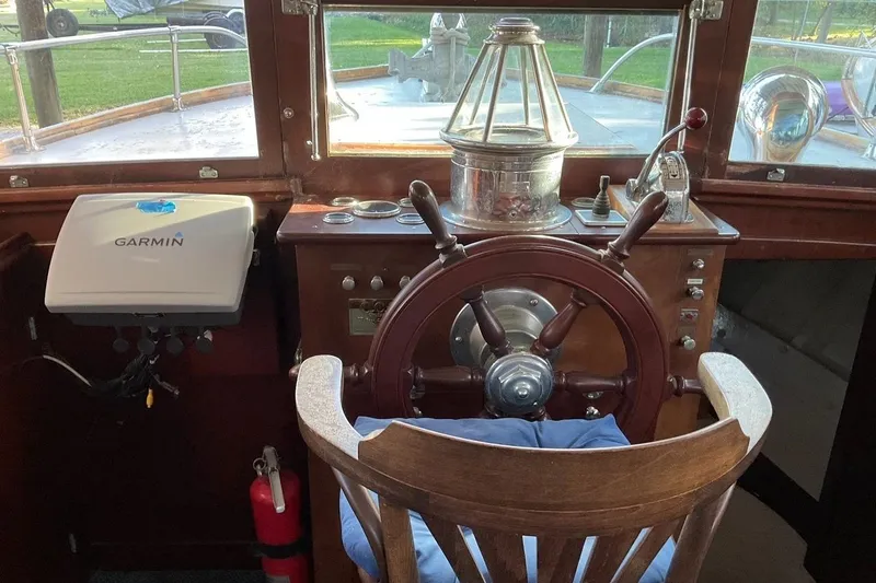 Slide: The Image of 1930 Classic 47' ACF boat helm with wooden wheel and Garmin navigation system. - 16