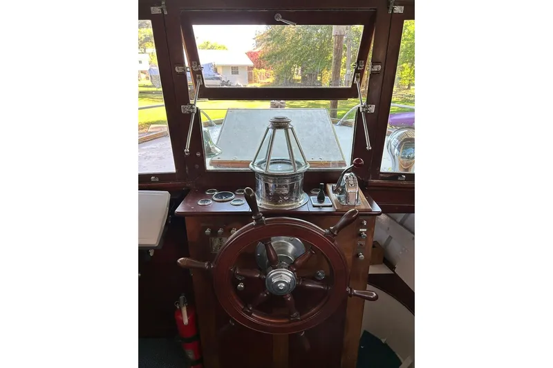 Slide: The Image of 1930 Classic 47' ACF boat helm with wooden wheel and vintage controls. - 18