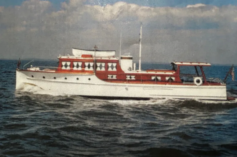 Slide: The Image of Classic 1930 47' ACF yacht cruising on open water under a cloudy sky. - 2