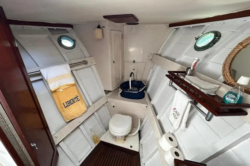 Slide: The Image of 1930 Classic 47' ACF yacht bathroom with nautical decor and porthole windows. - 20