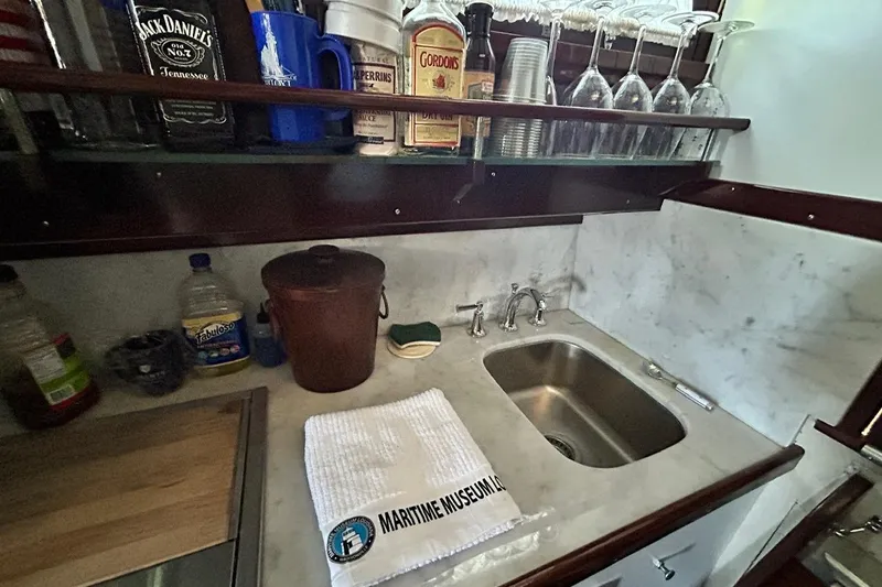 Slide: The Image of Galley of 1930 Classic 47' ACF yacht with marble countertop and vintage barware. - 23