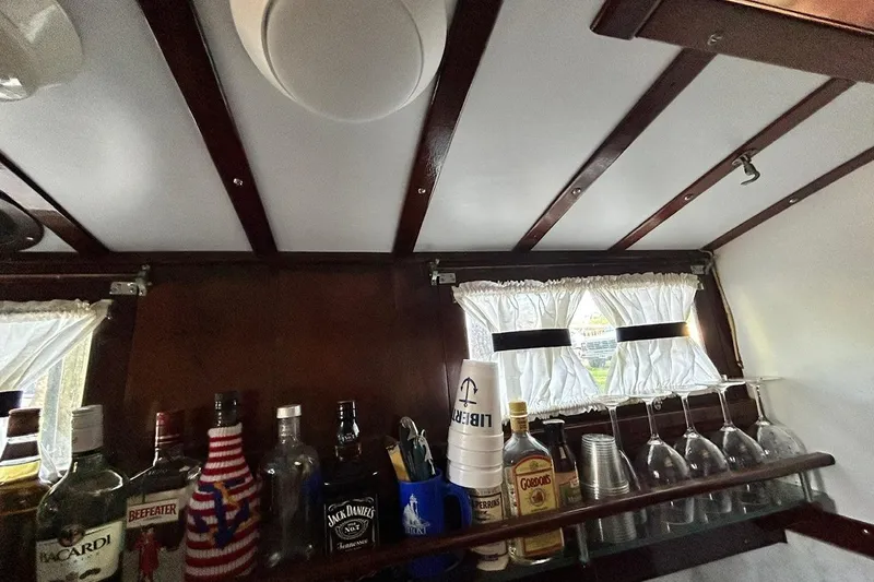 Slide: The Image of Interior of a 1930 Classic 47' ACF with a stocked bar and vintage decor. - 25