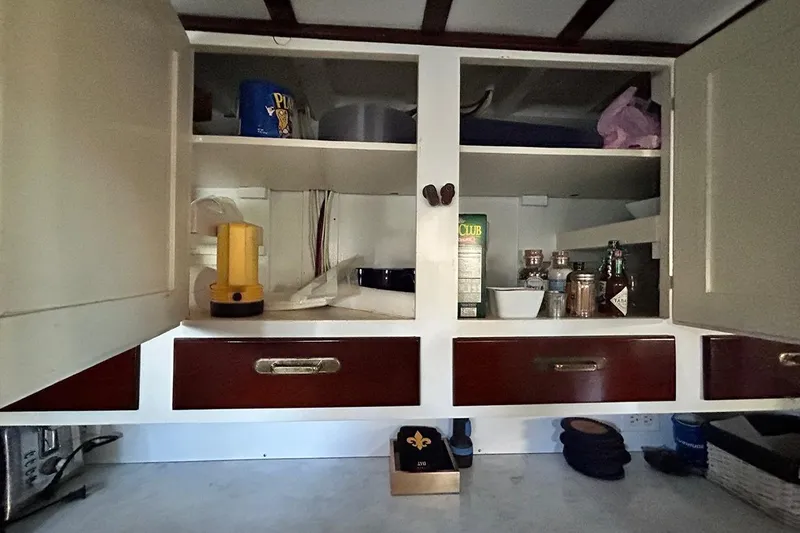 Slide: The Image of Open kitchen cabinet with assorted items on a 1930 Classic 47' ACF model. - 29