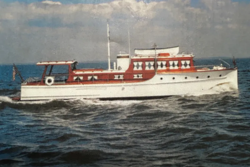 Slide: The Image of Classic 1930 47' ACF yacht cruising on open water under a cloudy sky. - 36