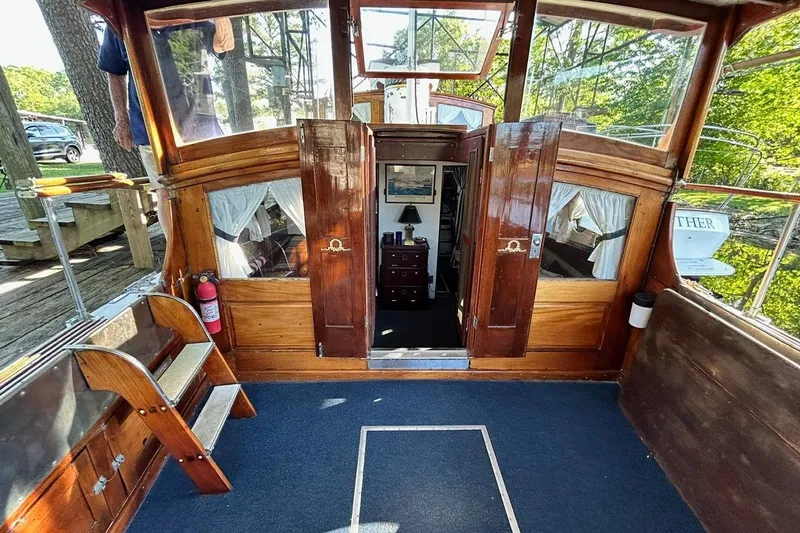 Slide: The Image of Interior view of a 1930 Classic 47' ACF boat with wooden details and cozy cabin. - 4