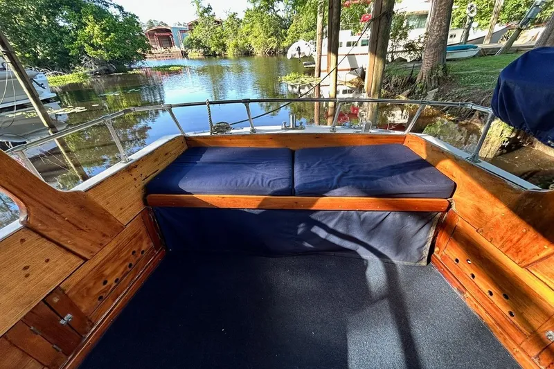 Slide: The Image of Interior of a 1930 Classic 47' ACF boat with wooden seating and blue cushions. - 6