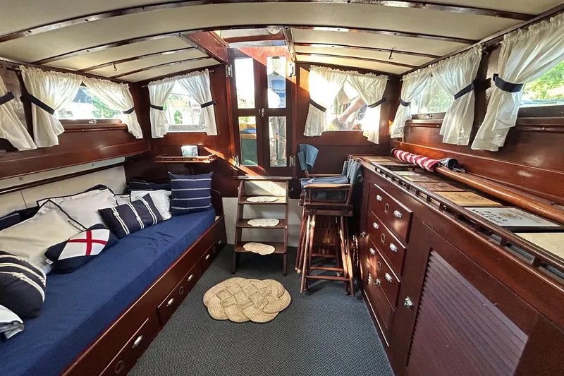 Slide: The Image of Interior of a 1930 Classic 47' ACF boat with wooden furnishings and nautical decor. - 8