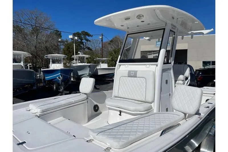 Slide: The Image of 2024 Sea Fox 251 Bay Fox boat with white seating and modern design. - 10