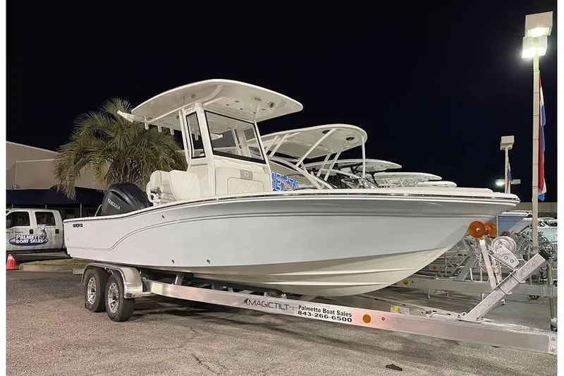 Slide: The Image of 2024 Sea Fox 251 Bay Fox boat on trailer at night, dealership setting. - 2