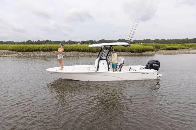 Slide: The Image of 2024 Sea Fox 251 Bay Fox boat with anglers fishing in a serene river setting. - 4
