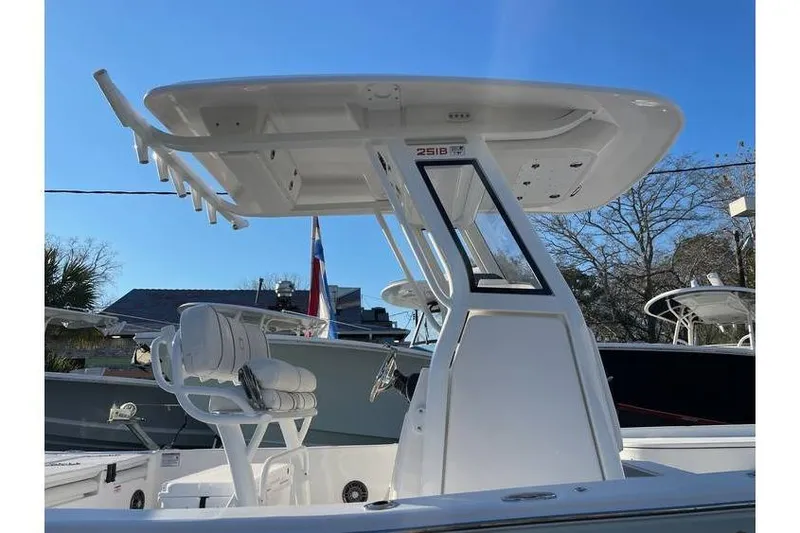 Slide: The Image of 2024 Sea Fox 251 Bay Fox boat with T-top and seating, displayed outdoors. - 5