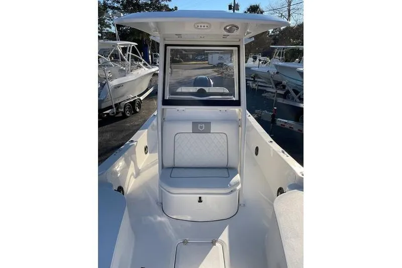 Slide: The Image of 2024 Sea Fox 251 Bay Fox boat interior with seating and console. - 8