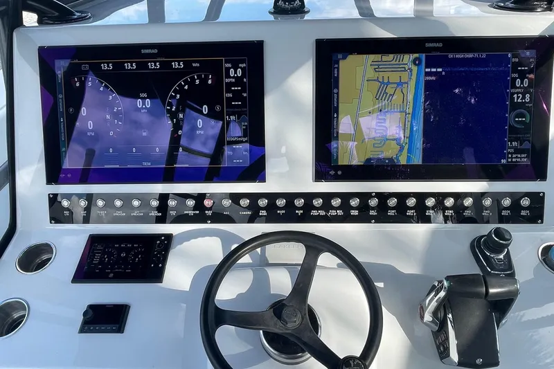 Slide: The Image of 2023 Conch 41 Center Console dashboard with dual Simrad displays and control panel. - 11